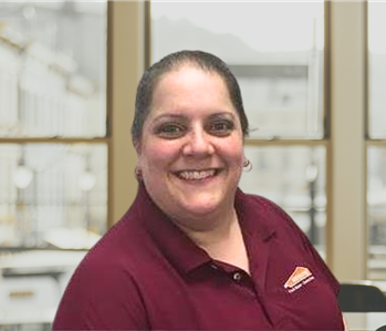 woman with pulled back brown hair and a red shirt