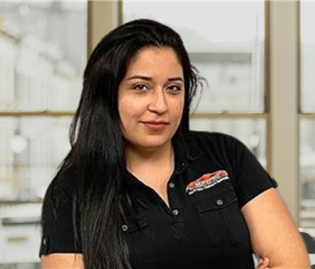 woman with long dark hair and a servpro shirt on