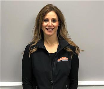 woman with long brown hair and servpro fleece jacket on
