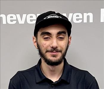 Young man with dark hair and a servpro hat