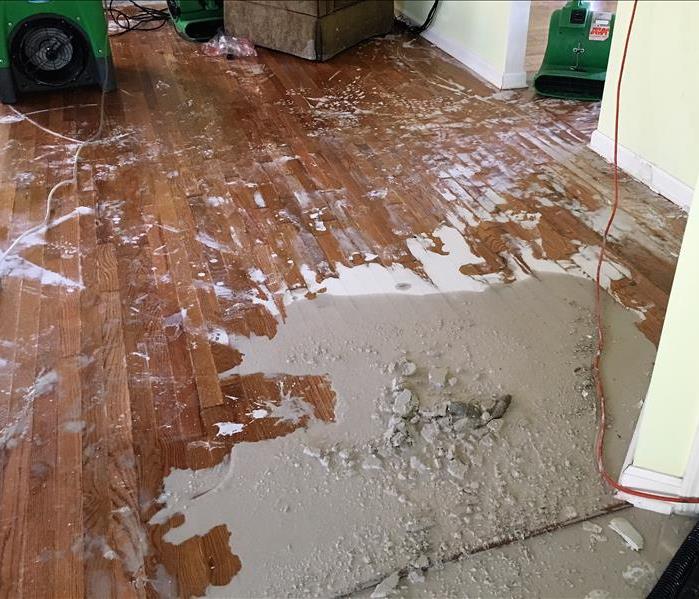 Mess on a wood floor after the ceiling collapsed 